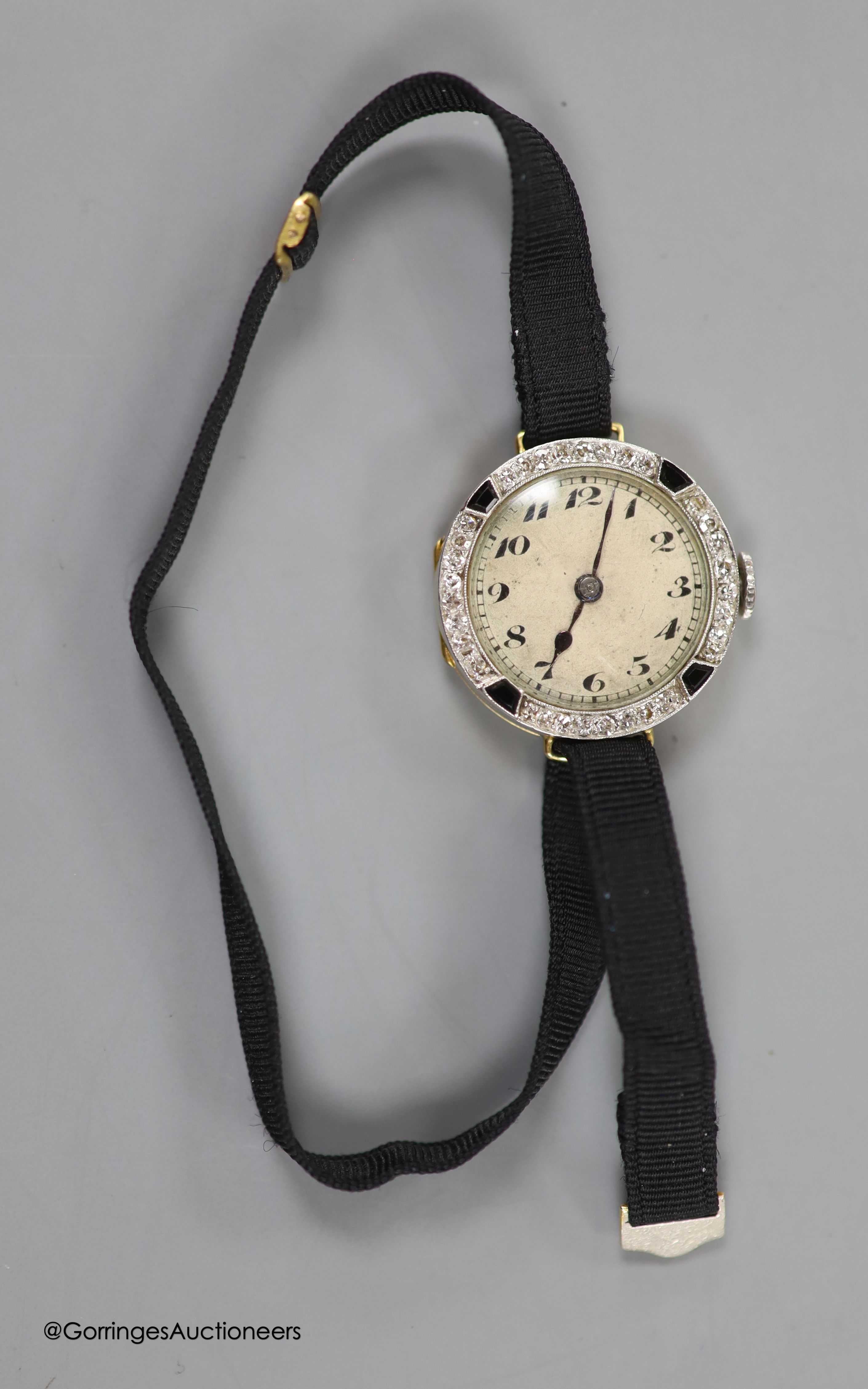 A lady's early 20th century 18ct gold, black onyx and diamond set cocktail watch, case diameter 21mm, on a fabric strap, gross weight 11.3 grams.